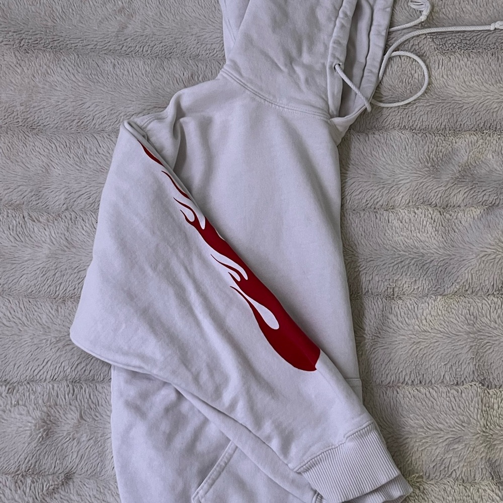 White hoodie with red flames on arms